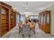 Dining room showcasing a formal table, chairs, a large window, and built-in shelving at 27003 Racquet Cir, Leesburg, FL 34748