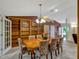 Dining area featuring a decorative table, elegant chairs, and ample built-in shelving at 27003 Racquet Cir, Leesburg, FL 34748