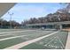 Daytime view of shuffleboard courts with covered seating, showcasing a leisure community amenity at 27003 Racquet Cir, Leesburg, FL 34748