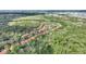 Sprawling aerial view of a residential community next to a lush forest and tranquil lake at 2754 Sun Key Pl, Kissimmee, FL 34747