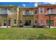 Townhome backyard with patio, balcony, and lush grass at 2754 Sun Key Pl, Kissimmee, FL 34747