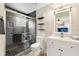 Well-lit bathroom features gray tiled shower with glass door and white vanity at 2754 Sun Key Pl, Kissimmee, FL 34747