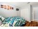 Well-lit bedroom featuring closet, wall art, TV, and bed with leafy patterned bedding at 2754 Sun Key Pl, Kissimmee, FL 34747