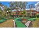 Community mini golf course is set among colorful homes and mature trees at 2754 Sun Key Pl, Kissimmee, FL 34747