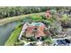 Aerial view of the pool and recreation center, showcasing nearby lake and lush landscaping at 2754 Sun Key Pl, Kissimmee, FL 34747