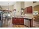 Functional kitchen area features stainless steel dishwasher and sink, breakfast nook, and laminate floors at 2903 Blooming Alamanda Loop, Kissimmee, FL 34747