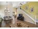 Bright living room featuring laminate wood flooring, high ceilings, and staircase with white railing at 2903 Blooming Alamanda Loop, Kissimmee, FL 34747