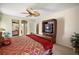 Spacious main bedroom with ceiling fan and entertainment center. View of the en suite bathroom at 2903 Blooming Alamanda Loop, Kissimmee, FL 34747