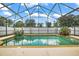 This backyard features an in-ground screened pool with beautiful surrounding plants and landscaping at 2903 Blooming Alamanda Loop, Kissimmee, FL 34747