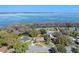 This aerial view highlights the home's location near a serene lake, offering picturesque waterfront views at 2918 Cocovia Way, Leesburg, FL 34748