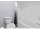 Clean bathroom featuring a white tile bathtub and toilet at 2918 Cocovia Way, Leesburg, FL 34748