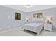 Well-lit bedroom featuring neutral colors, two windows, and minimalist décor at 2918 Cocovia Way, Leesburg, FL 34748