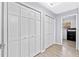 Hallway with wood floors and linen closets at 2918 Cocovia Way, Leesburg, FL 34748