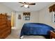 Bright bedroom features a ceiling fan and a comfortable blue comforter atop the bed at 31241 Benton Dr, Eustis, FL 32736