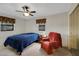 Relaxing bedroom with a window, featuring a decorative ceiling fan and comfortable seating area at 31241 Benton Dr, Eustis, FL 32736