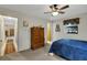 Comfortable bedroom boasts a ceiling fan, natural light, and classic wooden dresser at 31241 Benton Dr, Eustis, FL 32736