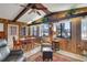 Bright dining area features wood-paneled walls, a ceiling fan, and views of the lake at 31241 Benton Dr, Eustis, FL 32736