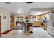 Modern kitchen with stainless appliances, center island, and view into the dining area at 31241 Benton Dr, Eustis, FL 32736