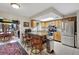 Bright kitchen featuring stainless appliances, a center island with bar stools, and view into the dining area at 31241 Benton Dr, Eustis, FL 32736