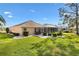 Lovely backyard with a screened lanai, manicured lawn and decorative rock beds add style and charm at 3163 Southern Trce, The Villages, FL 32162