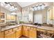 Bright bathroom featuring double sinks, granite countertops, and ample cabinet space at 3163 Southern Trce, The Villages, FL 32162