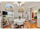 Cozy dining area with arched windows, a ceiling fan, and a table with ornate chairs at 3163 Southern Trce, The Villages, FL 32162