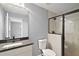 Bathroom featuring a black framed glass shower, a granite vanity, and neutral tiling at 35 Sequoia Loop Ct, Ocklawaha, FL 32179