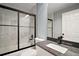 Modern bathroom with a sleek glass shower, granite countertops, and contemporary fixtures at 35 Sequoia Loop Ct, Ocklawaha, FL 32179