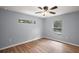 Bedroom with hardwood floors, neutral paint, and a window providing natural light at 35 Sequoia Loop Ct, Ocklawaha, FL 32179