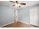 Bright bedroom featuring wood-look flooring, a ceiling fan, and a closet for ample storage at 35 Sequoia Loop Ct, Ocklawaha, FL 32179