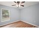 Bedroom with hardwood floors and window providing natural light at 35 Sequoia Loop Ct, Ocklawaha, FL 32179