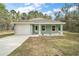 Charming single-story home with a well-manicured lawn and a one-car garage at 35 Sequoia Loop Ct, Ocklawaha, FL 32179