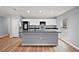 A modern kitchen with sleek gray island, stainless steel appliances, and white cabinets at 35 Sequoia Loop Ct, Ocklawaha, FL 32179