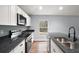 Kitchen with stainless steel appliances, black granite countertops, and white cabinets at 35 Sequoia Loop Ct, Ocklawaha, FL 32179