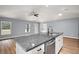 Kitchen island with granite countertop, stainless steel dishwasher, and pendant lighting at 35 Sequoia Loop Ct, Ocklawaha, FL 32179