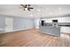 A combined kitchen-living room space with modern features and sleek flooring at 35 Sequoia Loop Ct, Ocklawaha, FL 32179