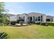 Inviting single-story home featuring a pristine lawn, manicured shrubs, and charming curb appeal at 3564 Nomad Ter, The Villages, FL 32163