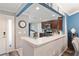 Well-lit kitchen with stainless steel appliances, dark cabinets, and an eat-in counter at 3564 Nomad Ter, The Villages, FL 32163