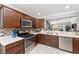 Modern kitchen featuring stainless steel appliances, tile backsplash, and ample counter space at 3564 Nomad Ter, The Villages, FL 32163