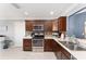 Updated kitchen featuring stainless steel appliances, dark wood cabinets, and stylish backsplash at 3564 Nomad Ter, The Villages, FL 32163