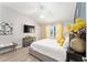 Cozy main bedroom featuring a queen bed, ceiling fan, and hardwood floors at 3564 Nomad Ter, The Villages, FL 32163