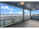 A covered balcony featuring wood-look floors, ceiling fans, and lake view at 481 Blue Cypress Dr, Groveland, FL 34736