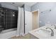 Well-lit bathroom with a shower over the tub and a double sink with quartz countertops at 481 Blue Cypress Dr, Groveland, FL 34736