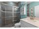 Modern bathroom featuring a tiled shower, white cabinets, granite countertops, and modern fixtures at 481 Blue Cypress Dr, Groveland, FL 34736