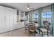 Dining area featuring white cabinets, a round table, and large windows with a lake view at 481 Blue Cypress Dr, Groveland, FL 34736