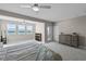 Bright main bedroom featuring plush carpeting, neutral walls, ceiling fan, and balcony access at 481 Blue Cypress Dr, Groveland, FL 34736