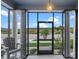 View from the screened in porch with tile floor and decorative columns at 481 Blue Cypress Dr, Groveland, FL 34736