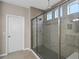 Large glass enclosed shower featuring multiple shower heads, custom tile work, and a bench at 481 Blue Cypress Dr, Groveland, FL 34736