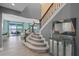 Elegant staircase featuring carpeted treads, modern railing, and views of the water at 481 Blue Cypress Dr, Groveland, FL 34736