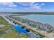 Aerial view of waterfront homes and boat docks on a lake at 481 Blue Cypress Dr, Groveland, FL 34736